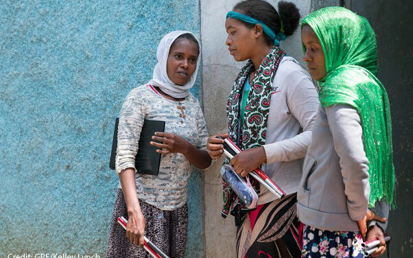 Visually impaired students chat outside class with their folding sticks in their hands, Oromia, Ethiopia