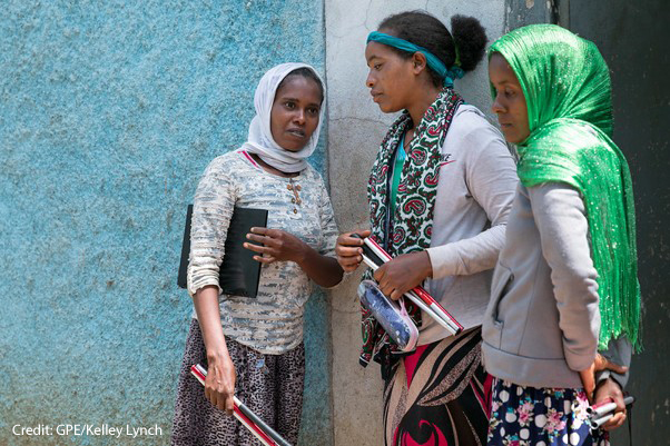 when straight ahead Visually impaired students chat outside class with their folding sticks in their hands, Oromia, Ethiopia