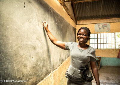 A female teacher, Risper, who specialises in the educational needs of disabled children, stands at the blackboard, Kenya.