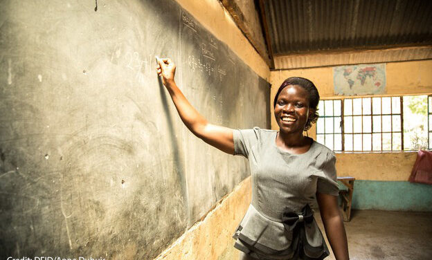 A female teacher, Risper, who specialises in the educational needs of disabled children, stands at the blackboard, Kenya.