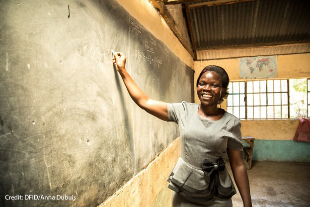 A female teacher, Risper, who specialises in the educational needs of disabled children, stands at the blackboard, Kenya.
