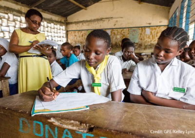 A female teacher stands in her classroom while the students do an exercise, Kenya.